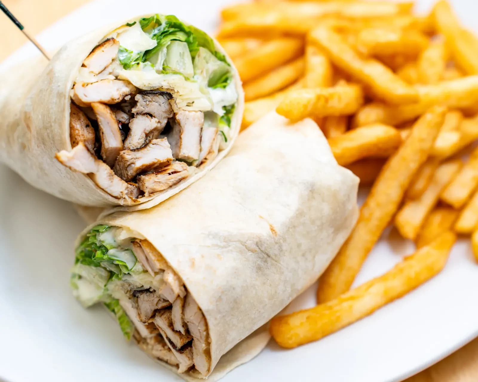Grilled chicken wrap served with french fries