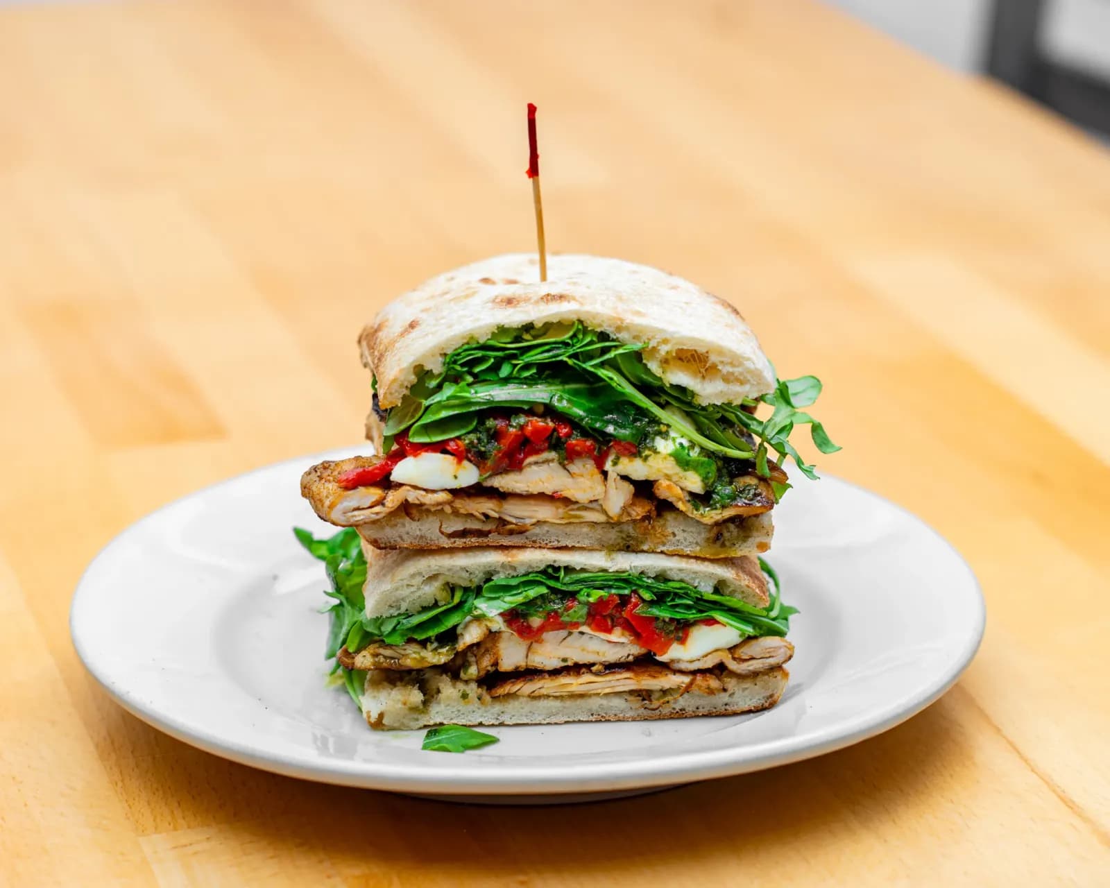 Stacked halves of a Panini Ala Italia on a plate