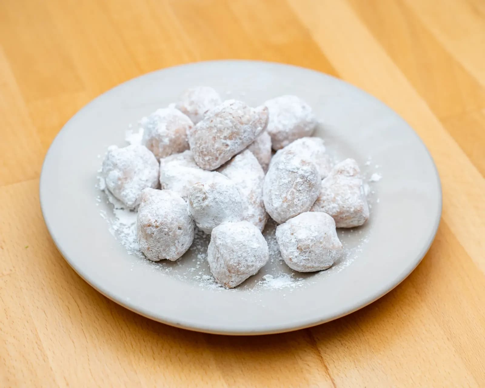 Plate of zeppole dusted with powdered sugar