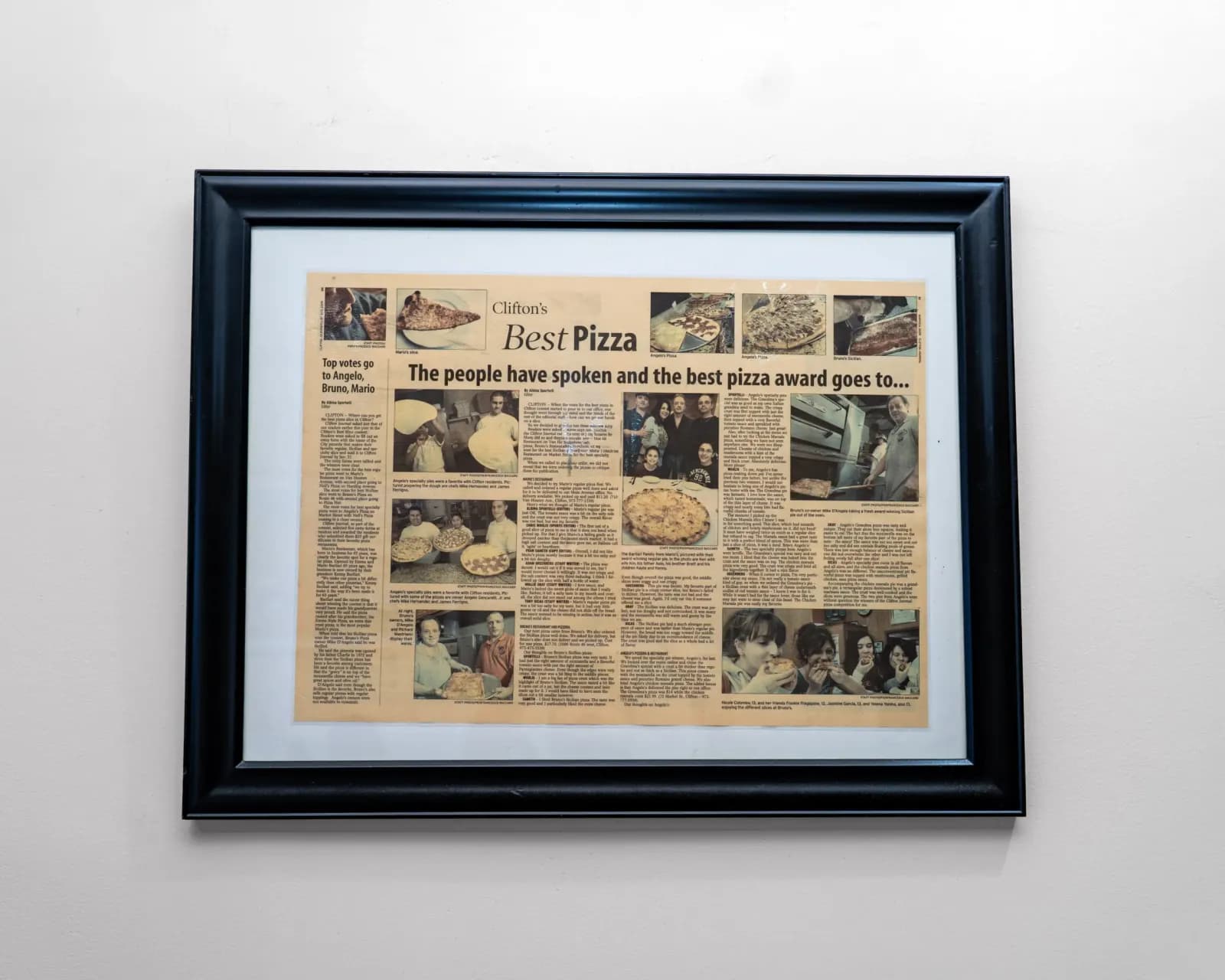 Framed newspaper feature about Angelo's hanging on the restaurant wall