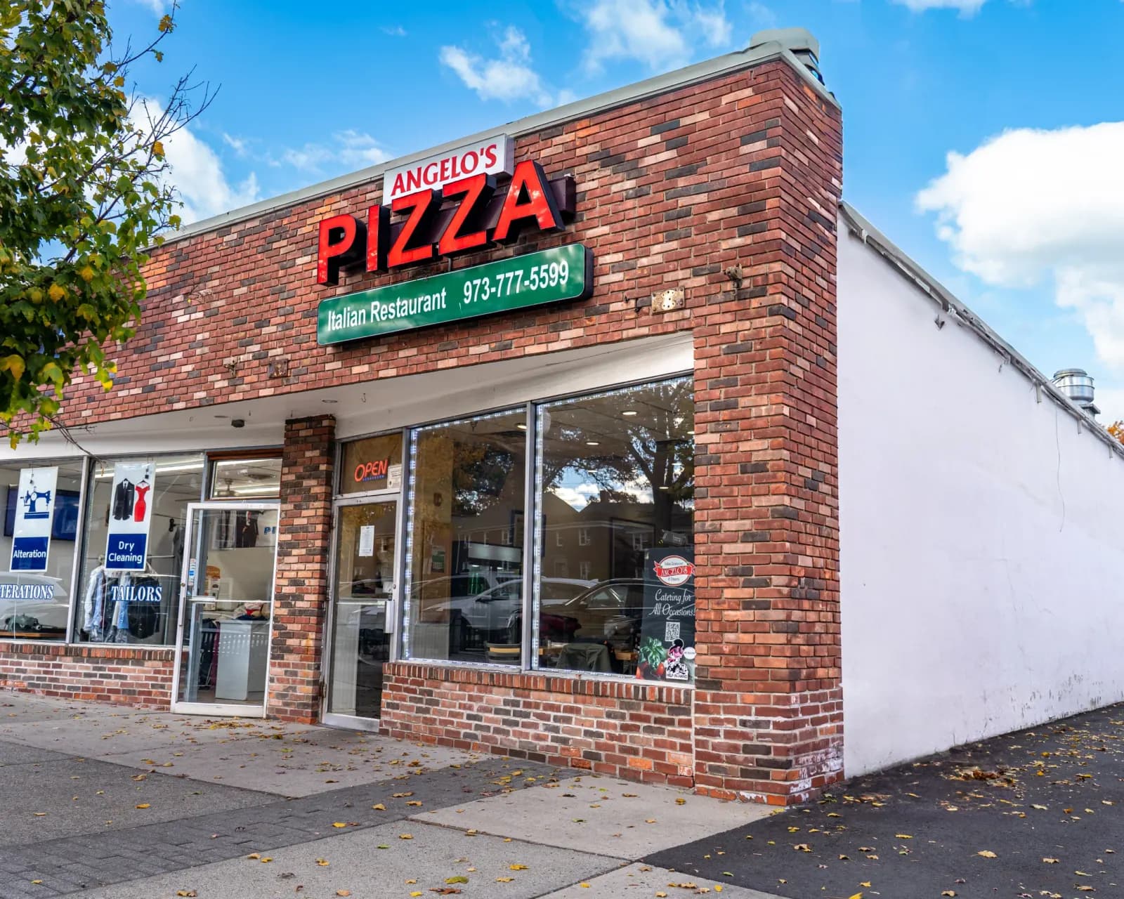 Angelo's Pizza storefront on Market St in Clifton, NJ, with its red Pizza sign and green Italian Restaurant banner