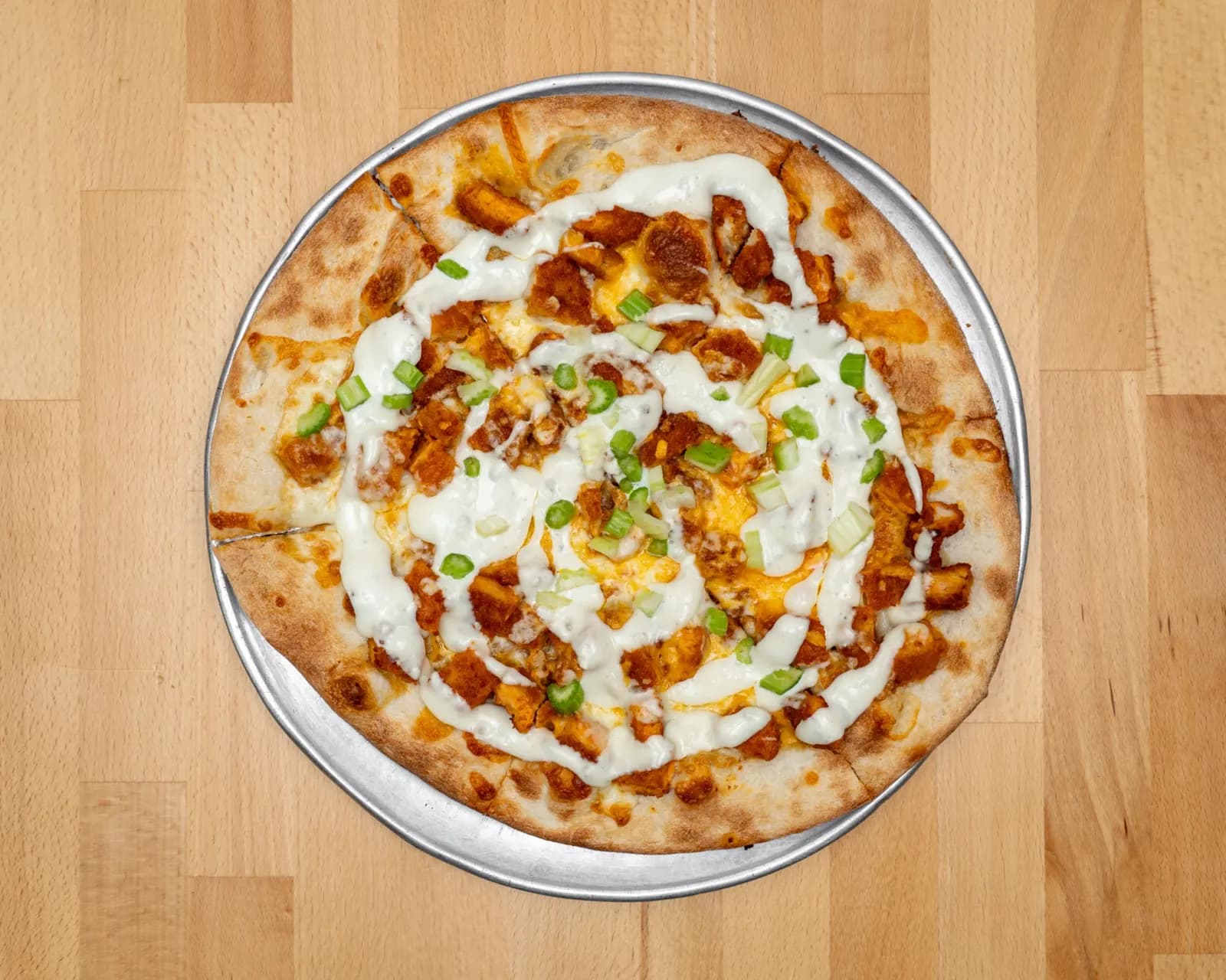 Buffalo chicken pizza drizzled with bleu cheese dressing